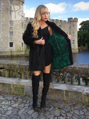 Dark green sheared beaver jacket with open front and draped collar over fitted dress