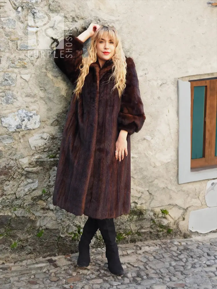 Dark brown mink fur coat with high collar and full-length button front, A-line fit