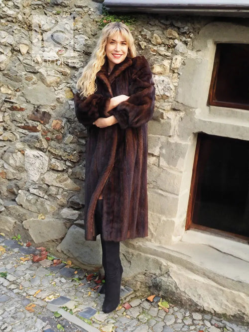 Dark mahogany-brown mink fur coat with wide collar and buttonless wrap look.