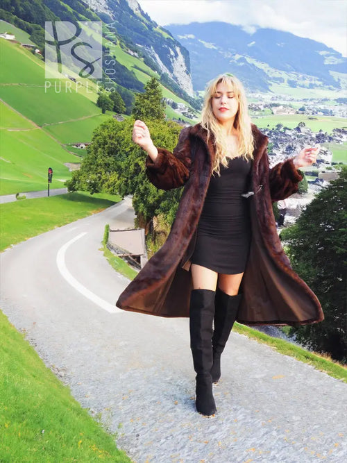 Long dark mahogany-brown mink fur coat with open front and voluminous fur sleeves.