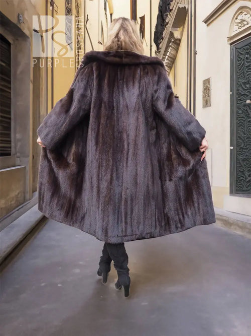 Back view of dark mink fur coat with notched collar, long sleeves, flared hem, knee length