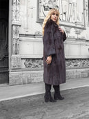 Dark mink fur coat with notched collar, long sleeves, relaxed standing pose.