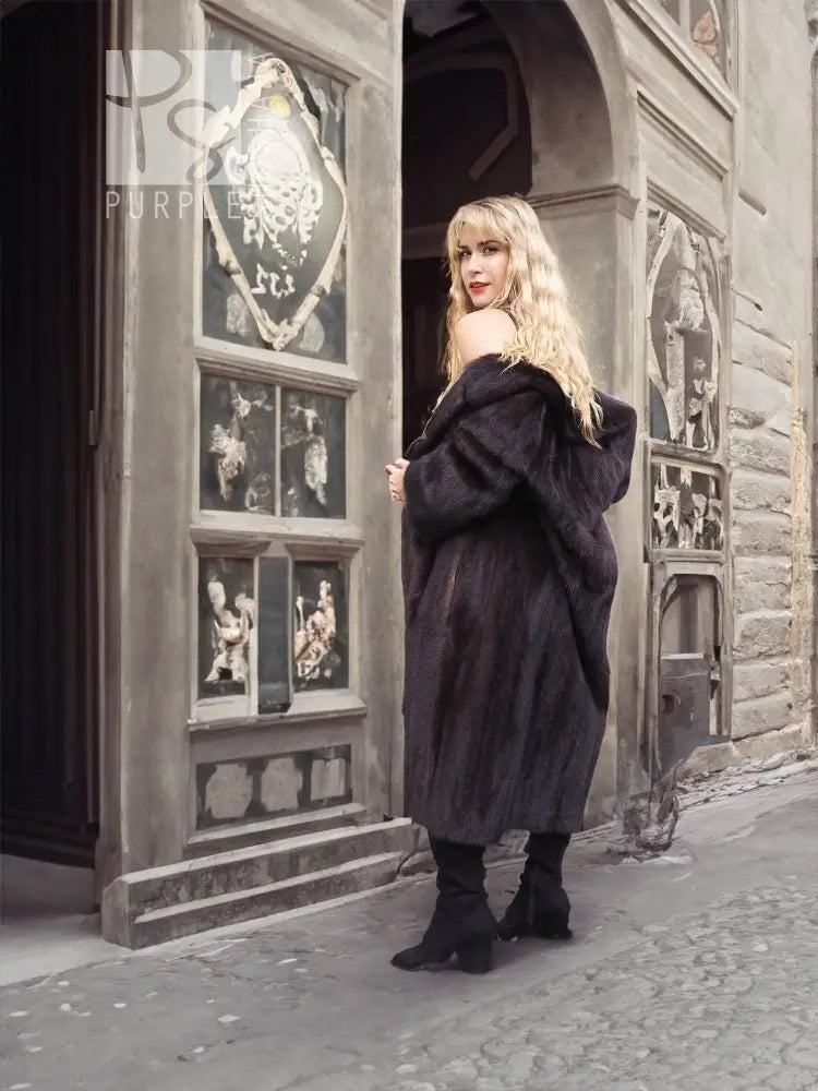 Black mink fur coat with hooded neckline and full sleeves, side view