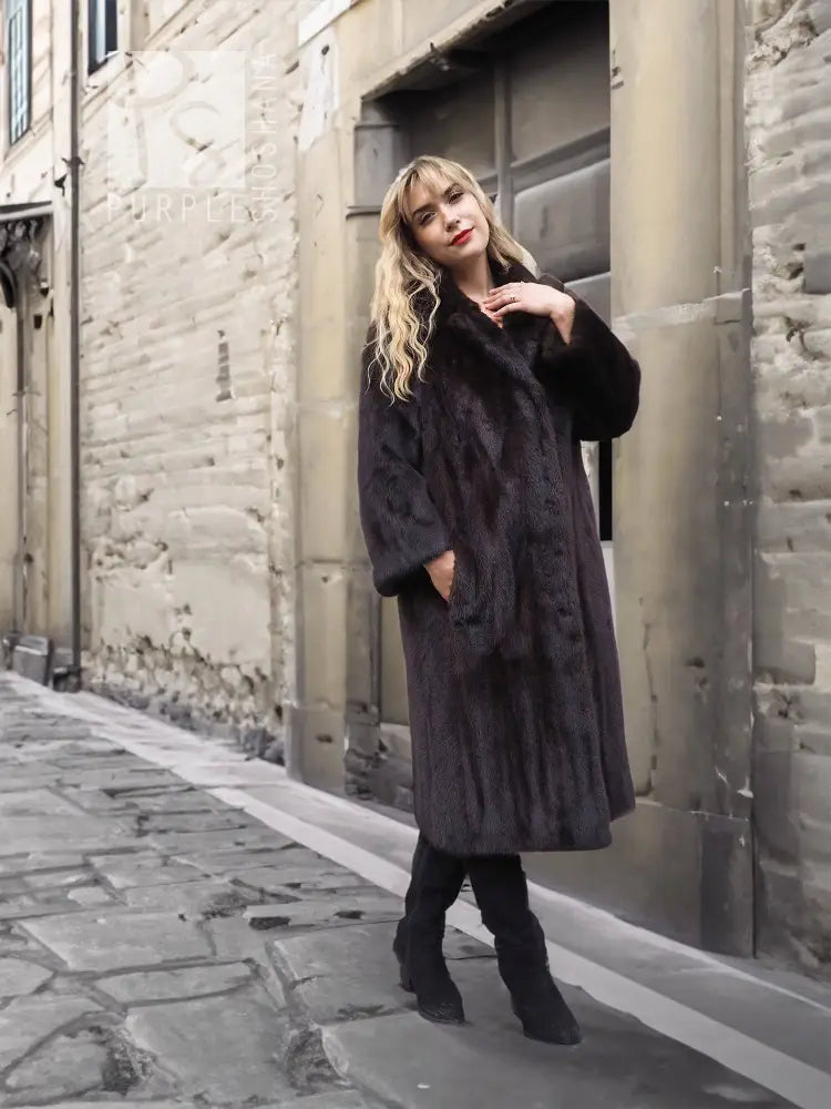 Dark mink fur coat, long sleeves and notched collar, full-length side view.