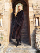 Black mink coat with dark fur collar and button front, full length, long sleeves