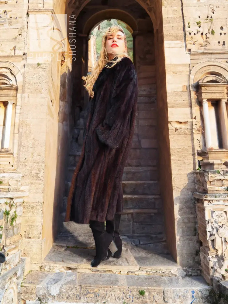 Black mink coat with dark fur collar and button front, full length, long sleeves