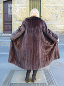 Back view of dark mink fur coat with black fox collar and full-length flared hem