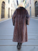 Full back view of long dark mink fur coat with black fox collar and straight hem