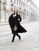 Black mink fur coat over black dress, front view with long flared coat hem