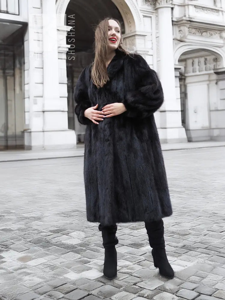 Black mink fur coat with buttonless front, long sleeves, knee-length hem