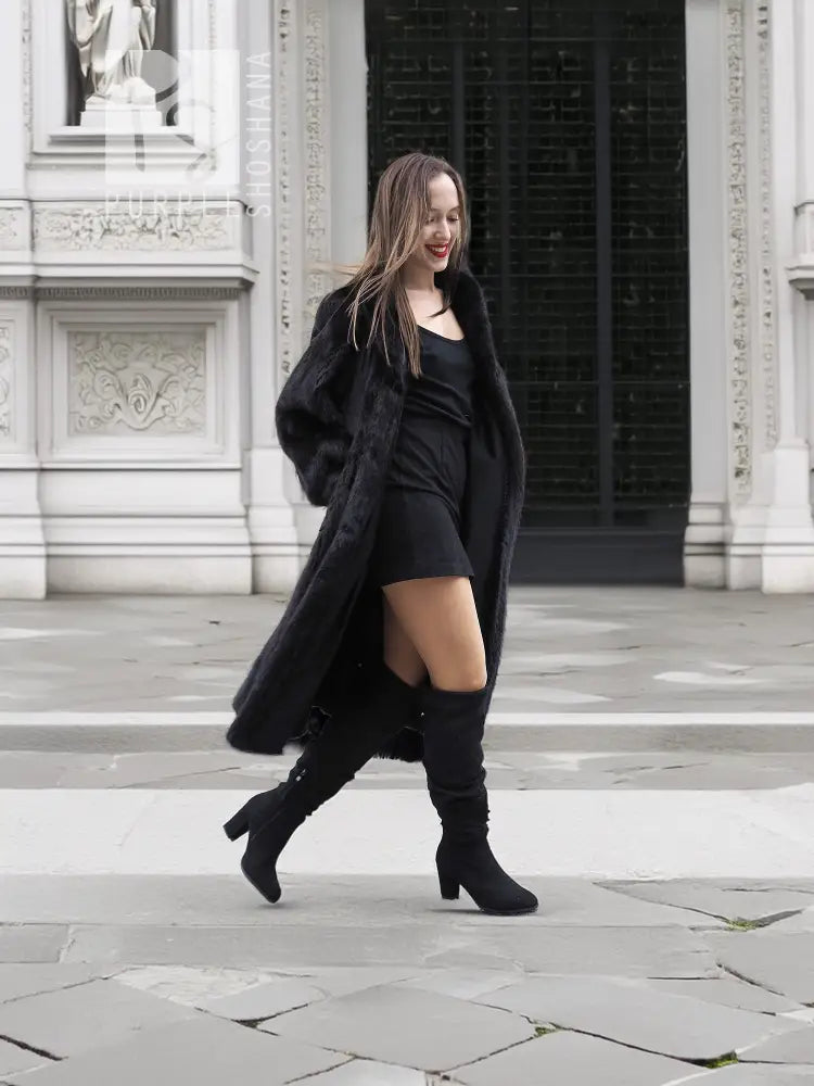 Black mink fur coat with open front, fitted waist and long sleeves, walking view