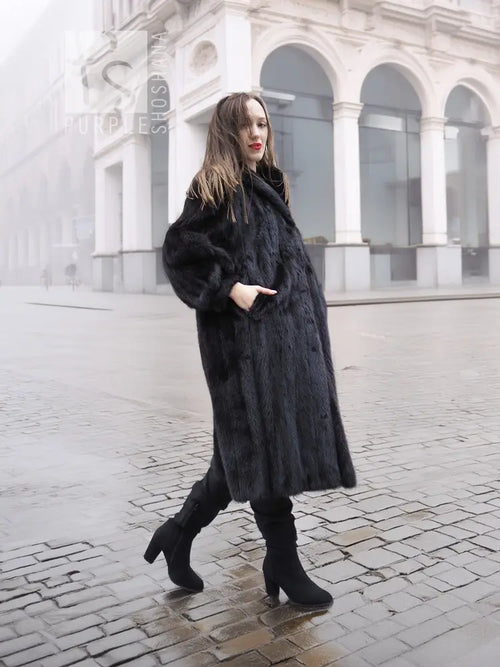 Black mink fur coat, three-quarter view with high collar and full skirt