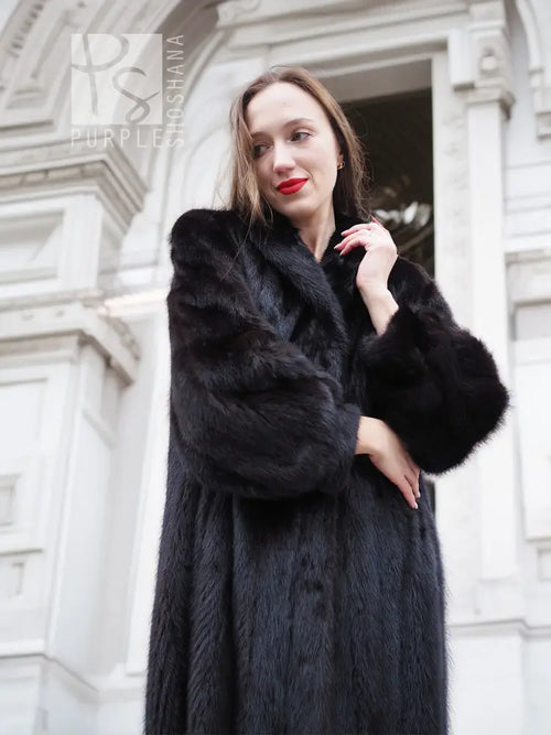 Black mink fur coat with thick collar, long sleeves, textured faux fur look