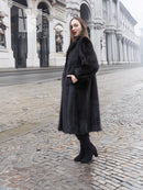 Black mink fur coat with high collar, long sleeves, mid-calf length