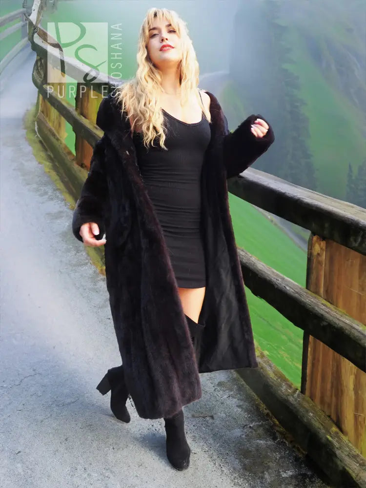 Black mink fur coat with hood, open front showing dark inner top and sleeves.