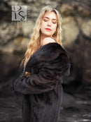 Black mink fur coat with hood, close-up of fur collar and shoulder.