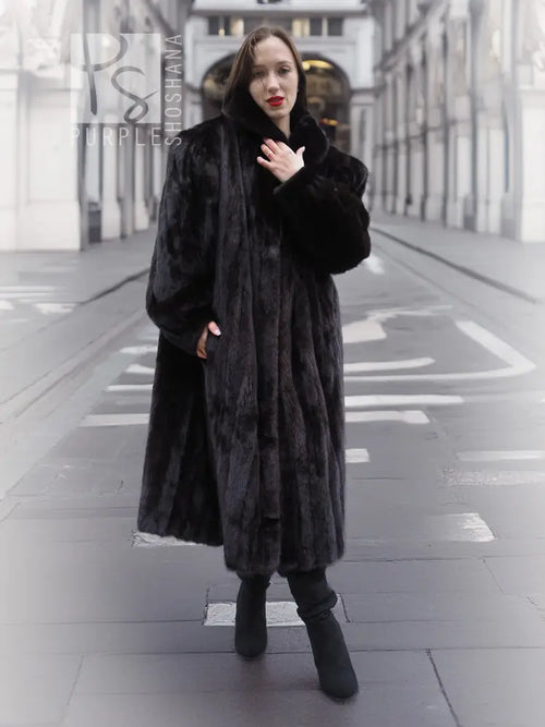 Black mink fur coat jacket with buttonless front and wide collar, walking front view.