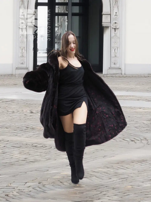 Dark mink fur coat with voluminous hooded collar, flared skirt and side drape