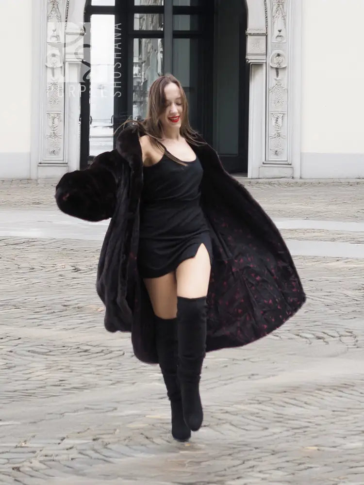 Dark mink fur coat with voluminous hooded collar, flared skirt and side drape