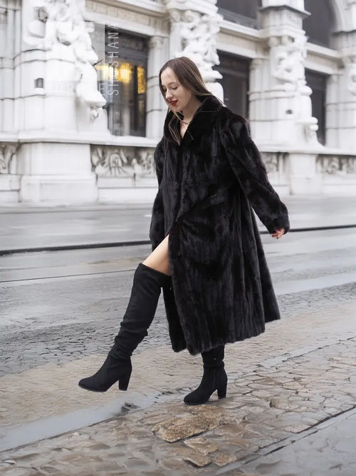 Black mink fur coat jacket with long sleeves and open front, knee-length hem.
