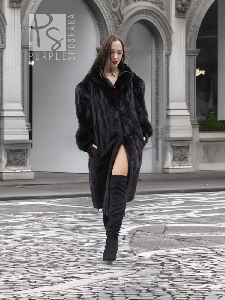 Black mink fur coat jacket with front wrap style and slit hem detail, full view.