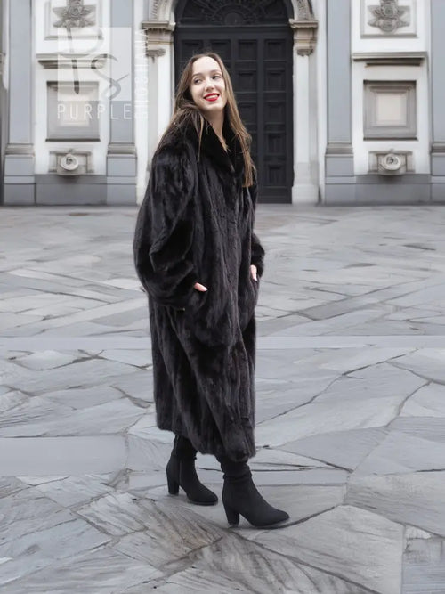 Black mink fur coat jacket with relaxed fit, long length, and wide collar, standing.