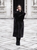 Black mink fur coat featuring a long, structured flare with notched collar and long sleeves.
