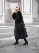 Black mink fur coat with long flared silhouette, notched collar, full sleeves, side pockets.