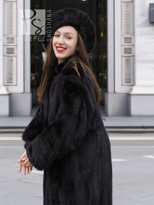 Black mink fur coat with wide collar, matching black fur hat, long sleeves