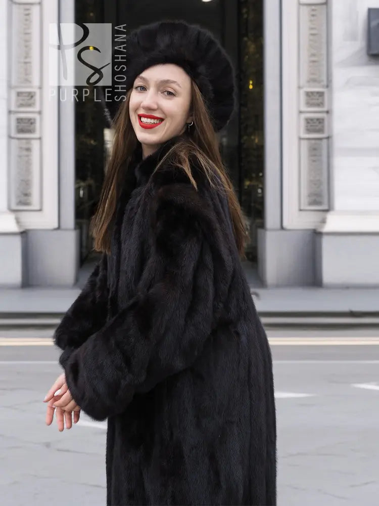 Black mink fur coat with wide collar, matching black fur hat, long sleeves