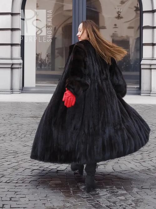 Black mink fur coat with full skirt flare and matching fur hat, long sleeves