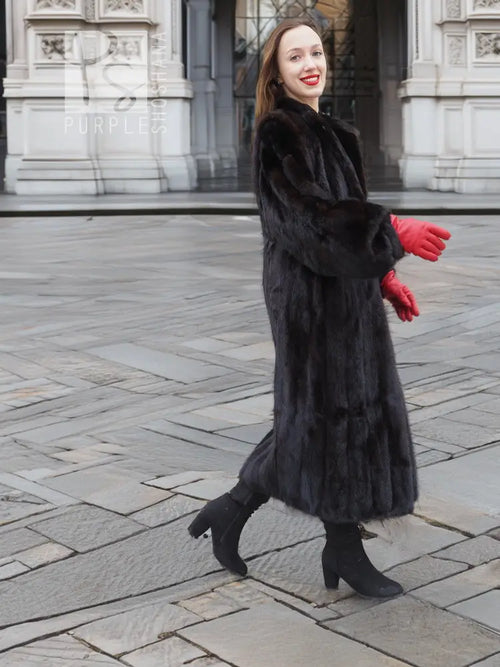 Black mink fur coat, side walking view, large fur collar and red gloves