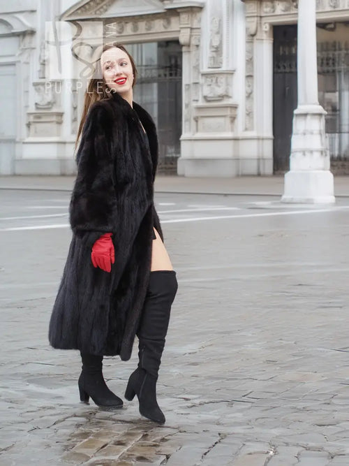 Black mink fur coat, profile view, open front with large fur collar, red gloves
