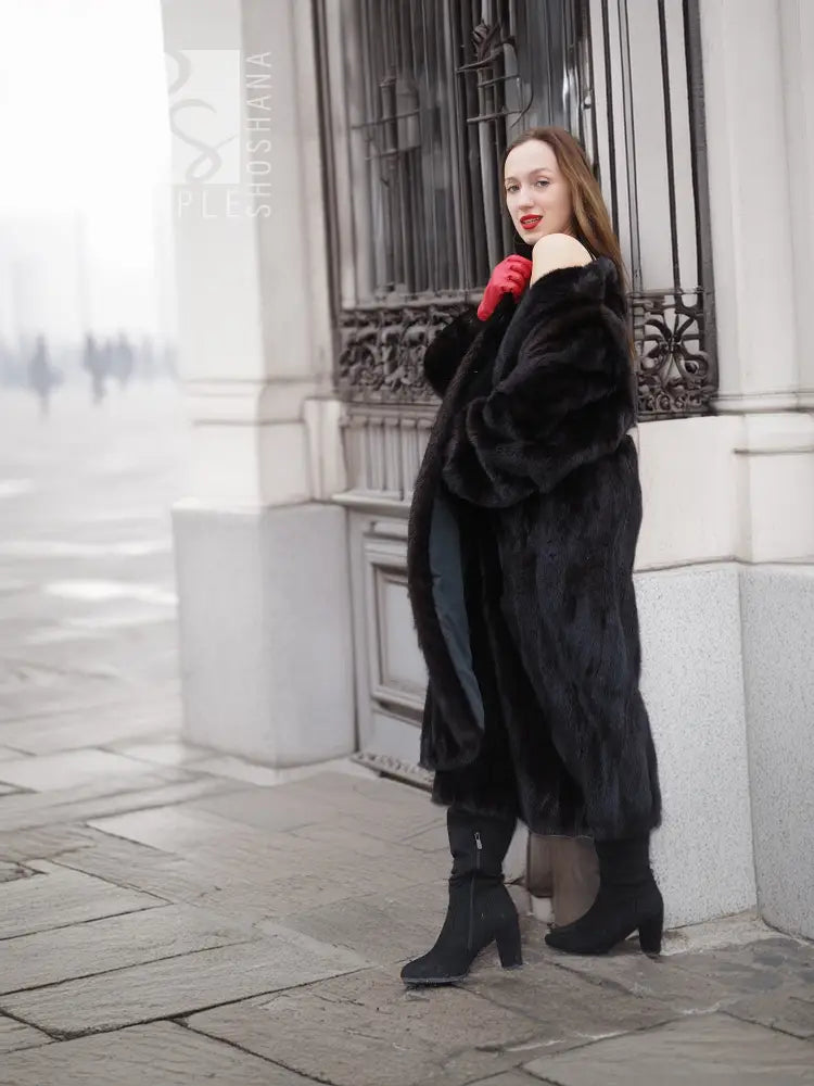 Black mink fur coat with wide collar, long sleeves, and side pockets