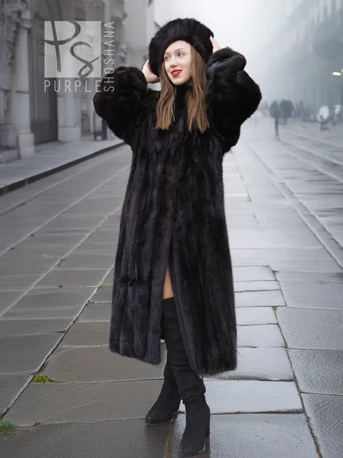 Black mink fur coat with full sleeves and large collar, paired with a matching mink hat
