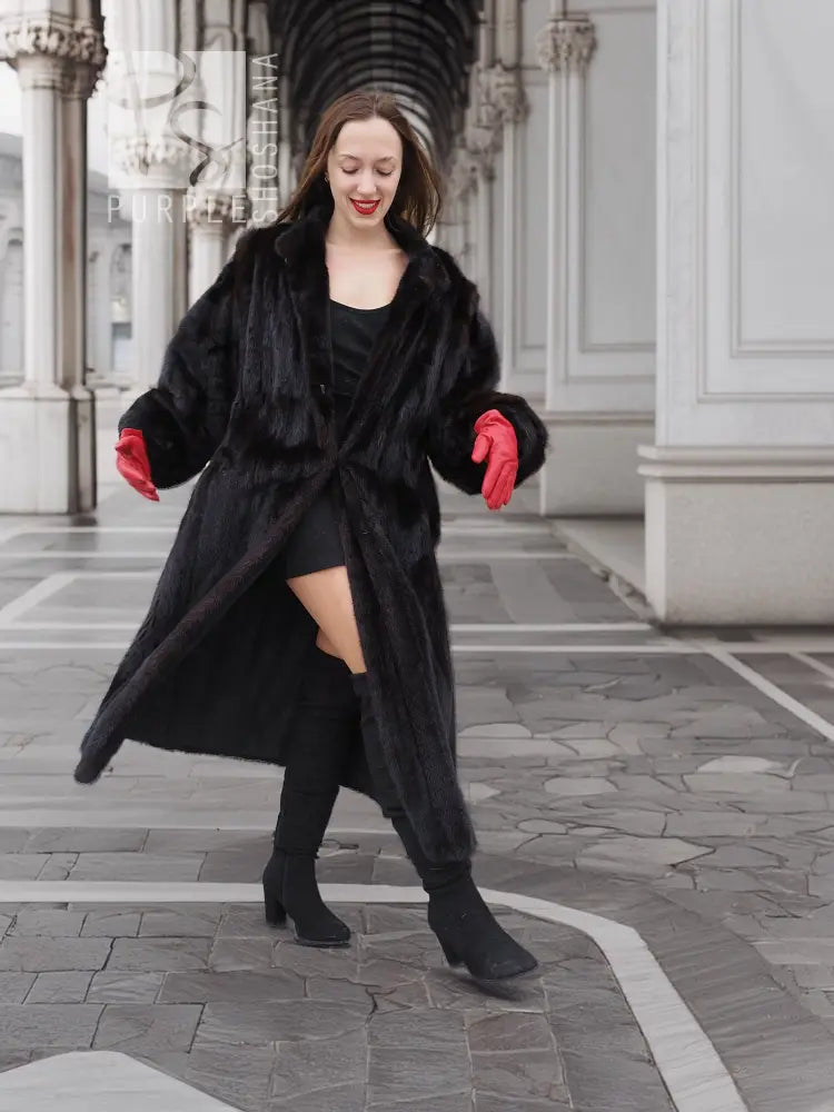Black mink fur coat with open front and curved hem, red gloves, boots