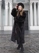 Black mink fur coat with thick fur texture, matching black fur hat, long sleeves