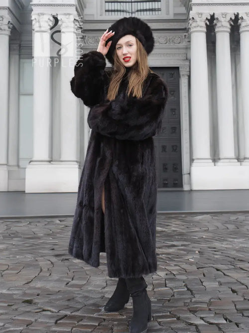 Black mink fur coat with thick fur texture, matching black fur hat, long sleeves