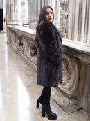 Black mink fur jacket with plush texture, mid-thigh length, three-quarter front view.
