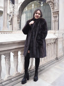Black mink fur jacket with high collar and long sleeves, front view.