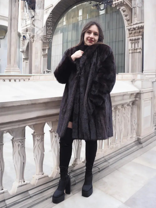 Black mink fur jacket with high collar and long sleeves, front view.