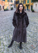 Long dark mink fur jacket with notched collar and full sleeves, front standing view