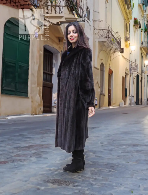 Women's long black mink fur jacket with button front and stand collar