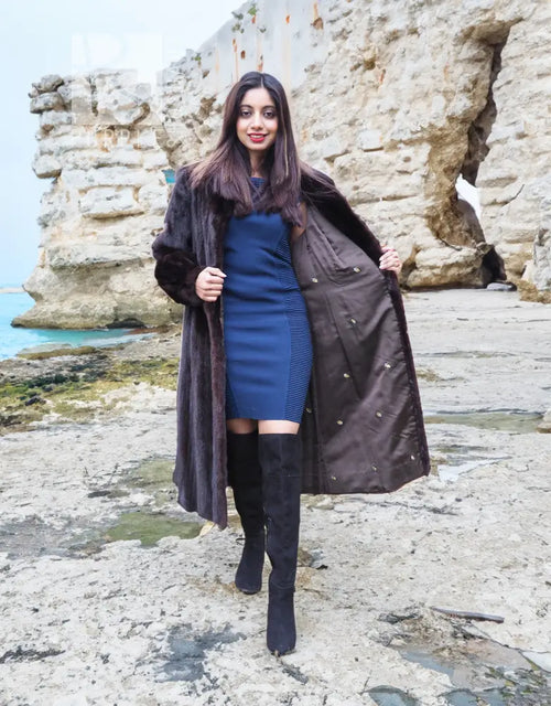 Dark mink fur long coat with notched collar and draped front, standing pose