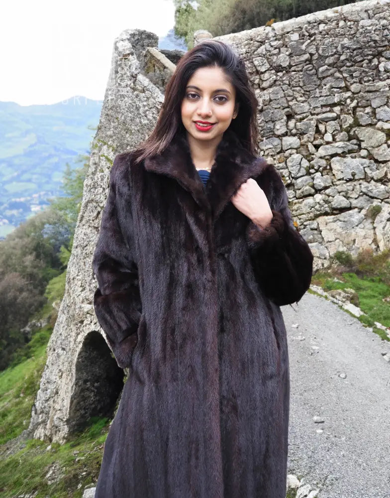 Dark mink fur coat with notched collar and roomy sleeves, front view