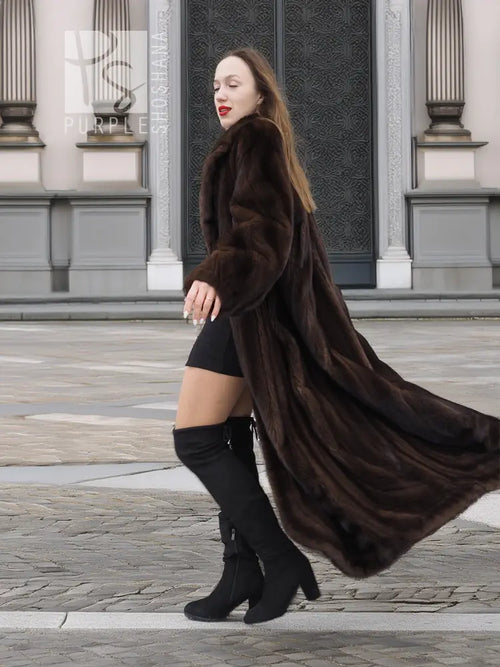 Long dark brown mink fur coat with deep collar, open front over black outfit