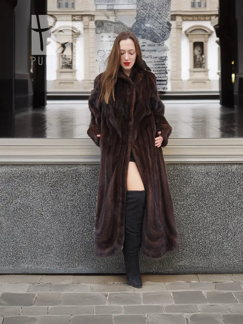 Dark brown mink fur coat with hood, open front and long sleeves over boots