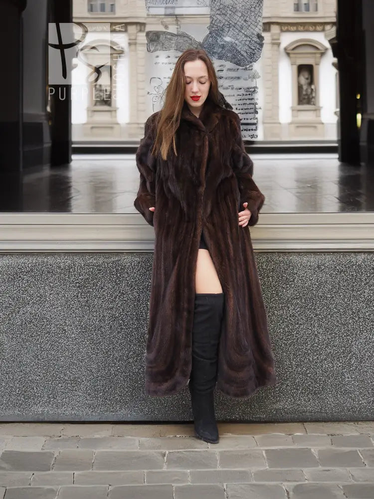 Dark brown mink fur coat with hood, open front and long sleeves over boots