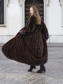 Long dark brown mink fur coat with wide shawl collar, open front and flowing hem