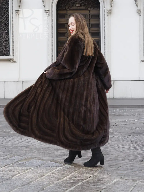 Long dark brown mink fur coat with wide shawl collar, open front and flowing hem